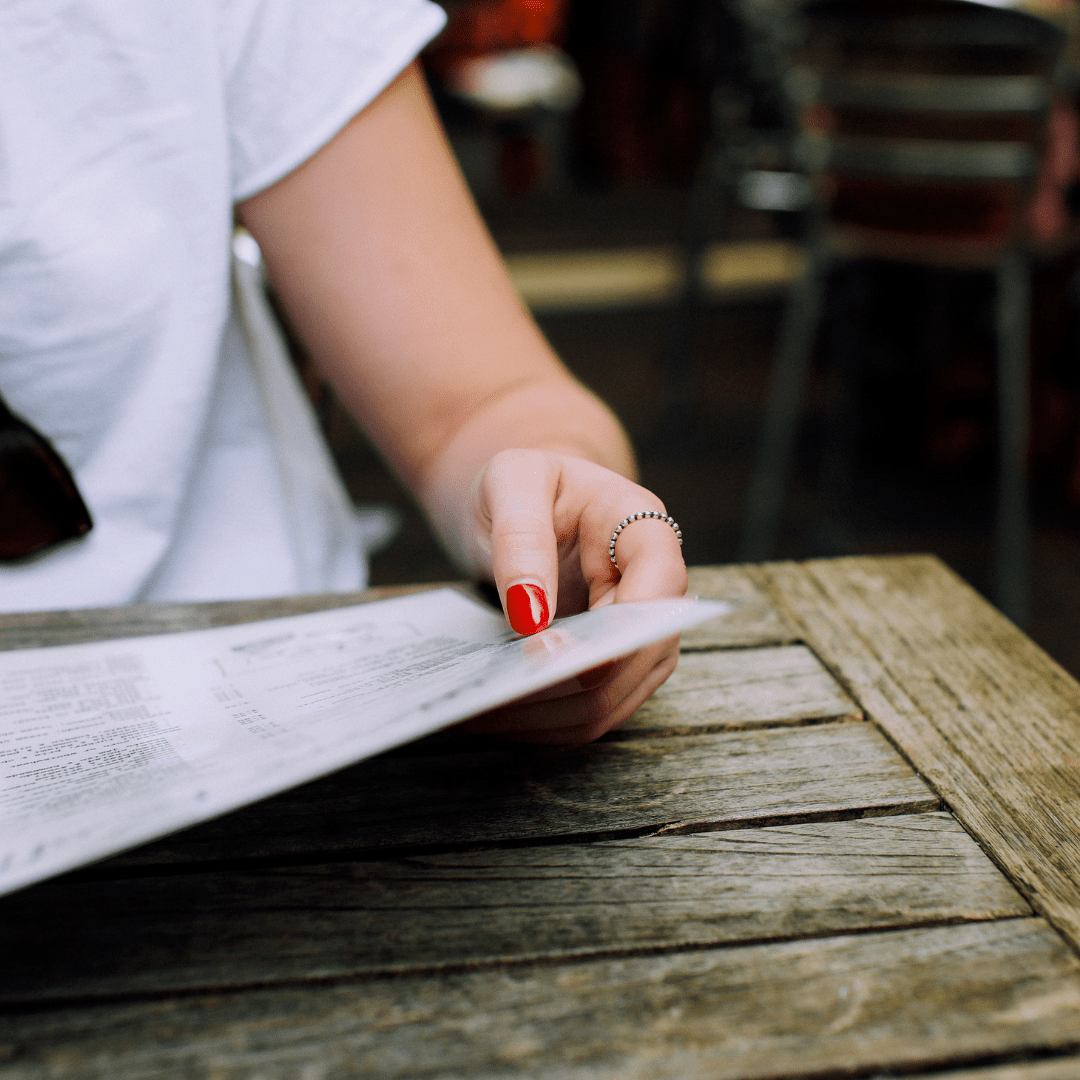 girl looking at restaurant menu