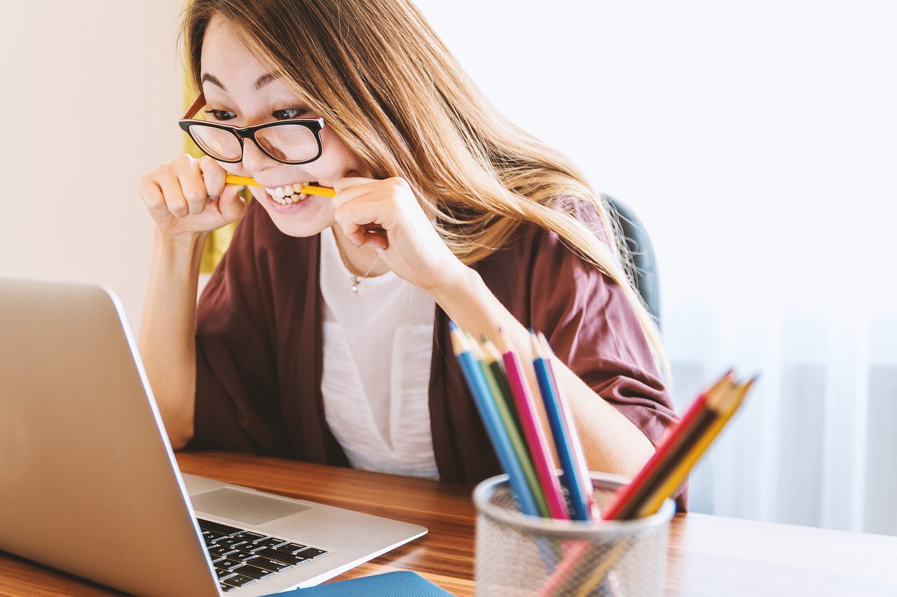 women biting a pencil feeling stressed out